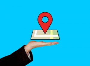 Hand holding up a GMB Maps Listing Pin