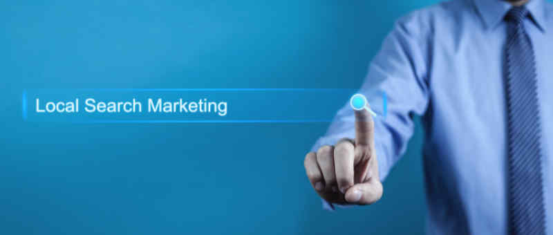 Businessman pressing Local Search Marketing button.
