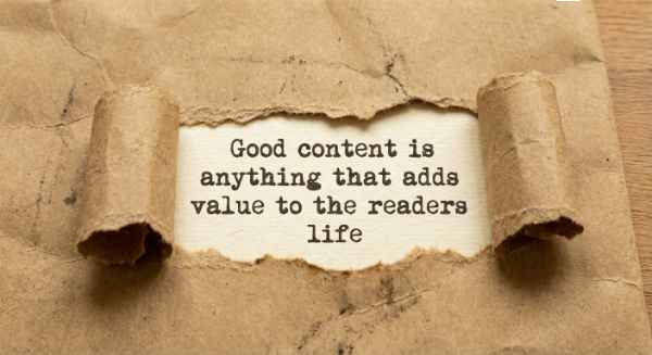 The content marketing quote, "Good content is anything that adds value to the readers life," revealed behind torn brown paper.
